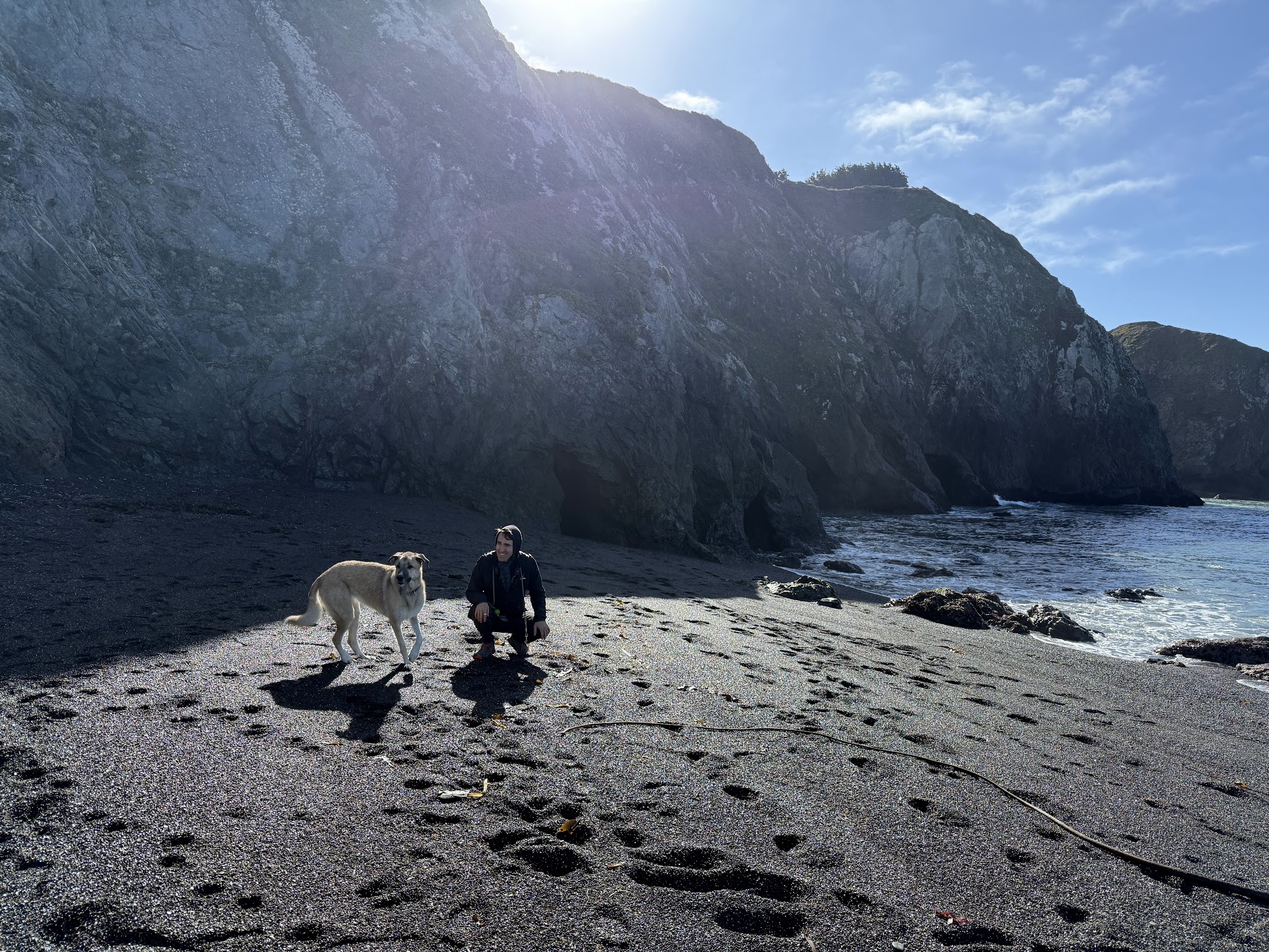 Tomas and Lola on a black sand beach